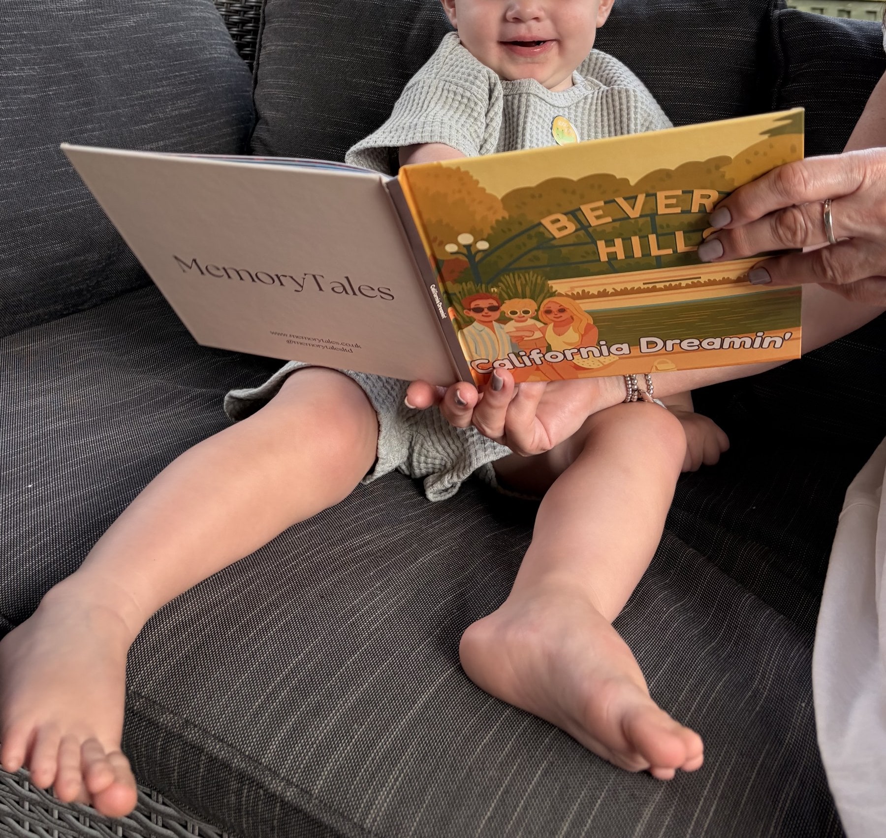 A toddler's hands holding open a personalised MemoryTales storybook